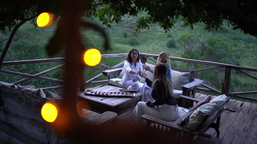 Guests gathered on a verandah at dusk